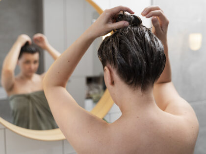 young woman applying anti dandruff product 1 Lara Sense
